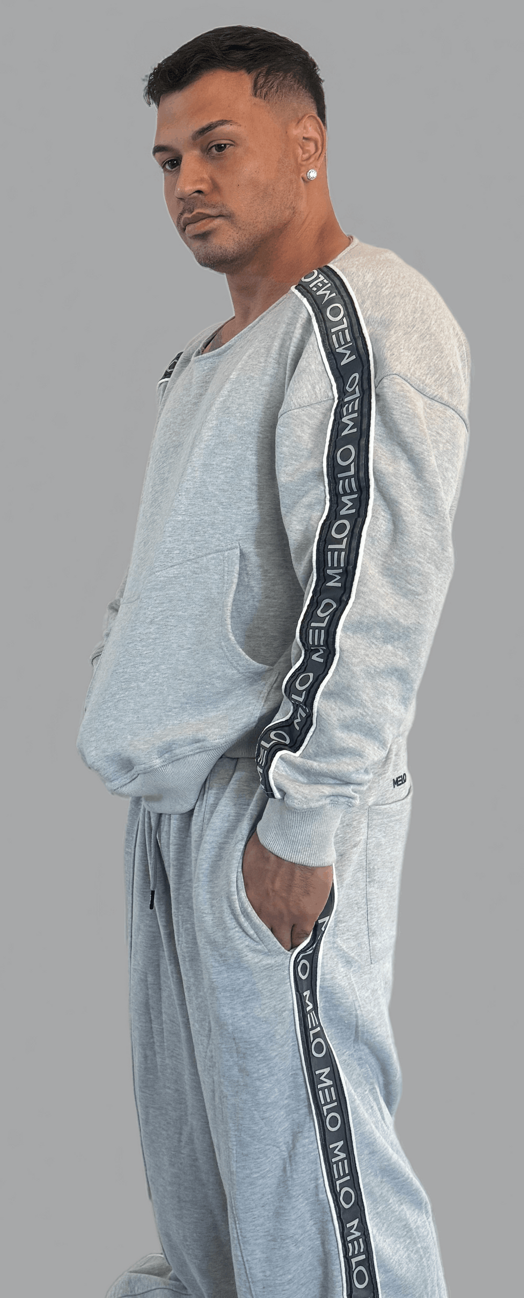 Man wearing the GOAT SWEATSUIT🐐, featuring a boxy style sweatshirt and loose, wide-leg pants.