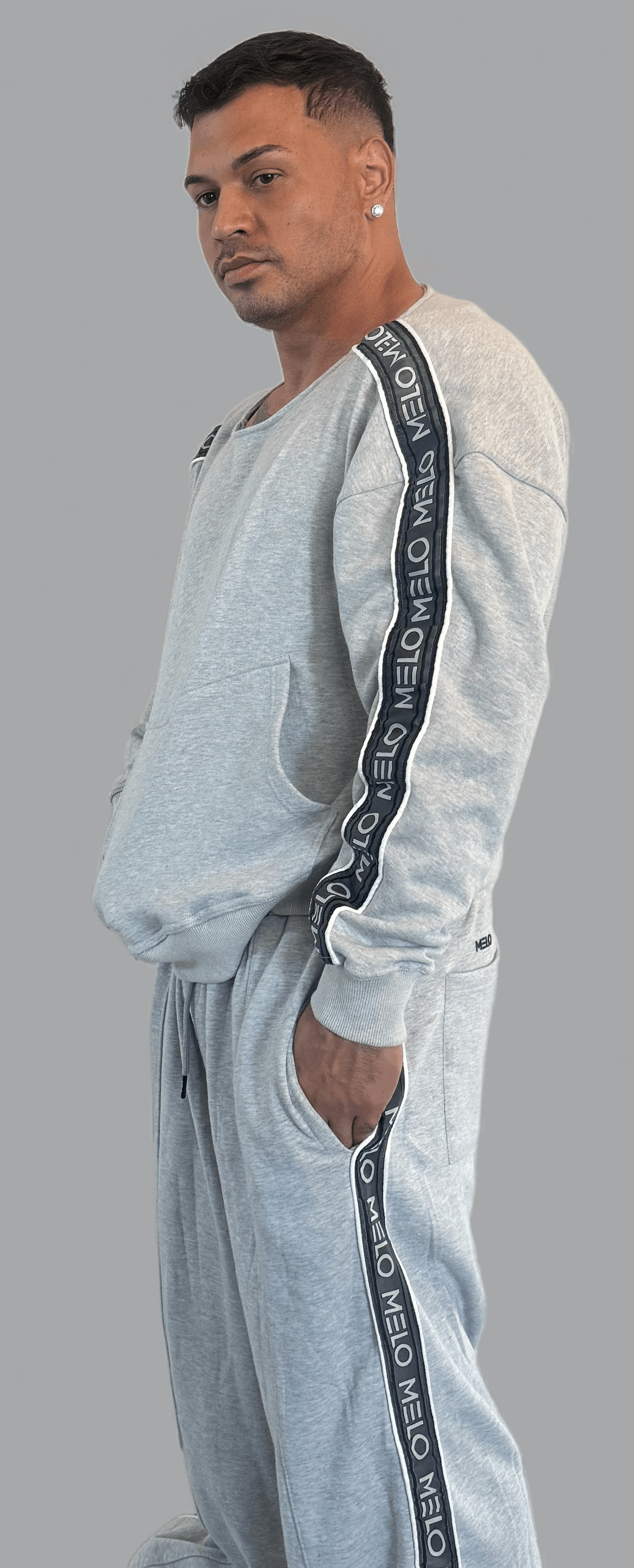 Man wearing the GOAT SWEATSUIT🐐, featuring a boxy style sweatshirt and loose, wide-leg pants.